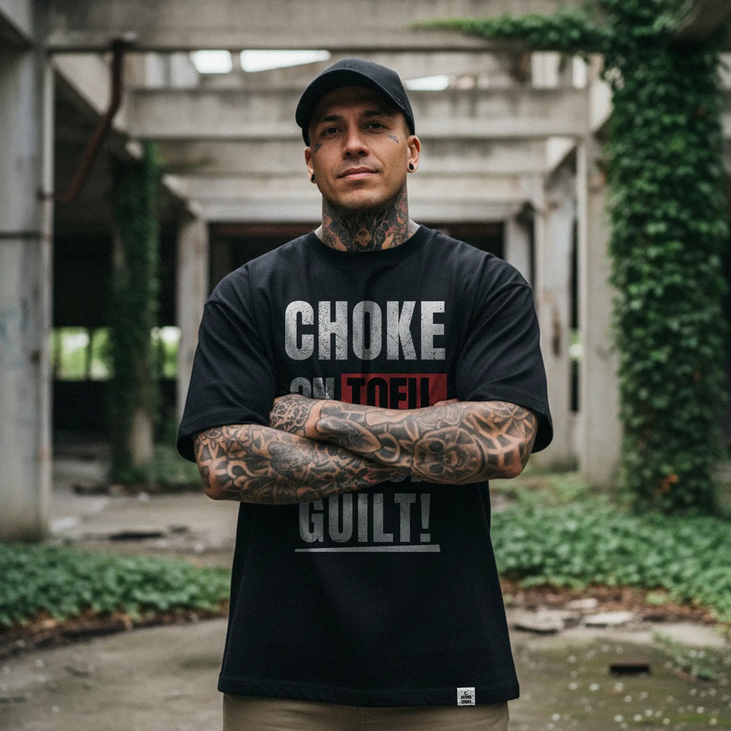 Nachhaltiges Oversized Unisex T-Shirt in Schwarz mit dem Frontprint „Choke on Tofu, not on Guilt!“ – Stanley/Stella Freestyler von Natura Umbra, getragen von einem männlichen Model.